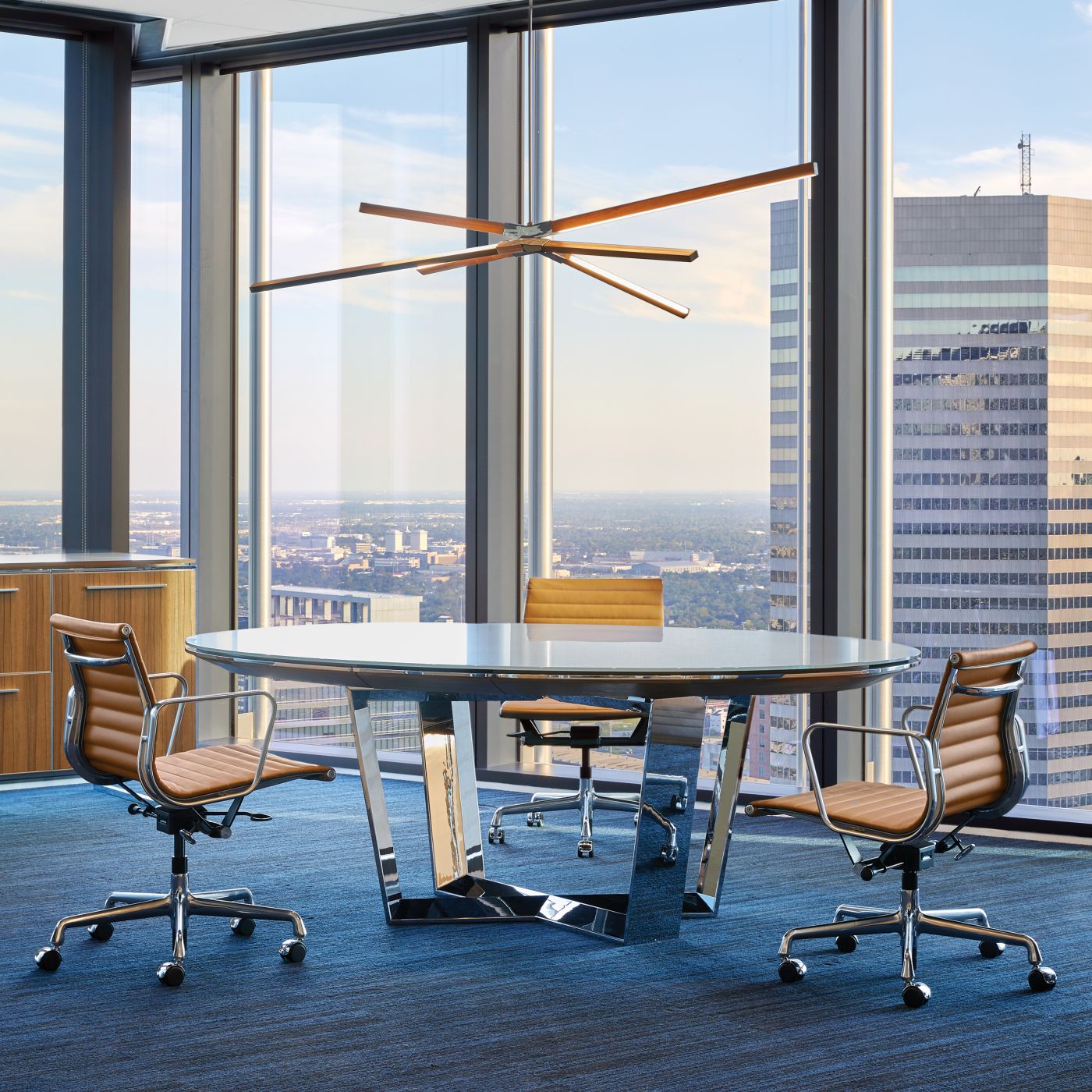 A MESA table in Glass and Polished Chrome centers this exquisite meeting space.